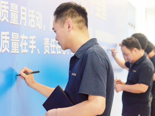 Kinglight employees signed on the "Quality Month" campaign wall